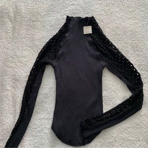 Free People mid Turtleneck Ribbed Top with detailed sleeves.